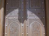 Muscat 04 Grand Mosque 04 Entrance Door Outside Here is the ornate door at the entrance to the main musalla (prayer hall), which is square with each side with an external dimension of 74.4m. The main musalla can hold over 6,500 worshippers, The much smaller women�s musalla can accommodate 750 worshippers. The outer paved ground can hold 8,000 worshippers and there is additional space available in the interior courtyard and the passageways, making a total capacity of up to 20,000 worshippers